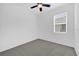 Carpeted bedroom features a ceiling fan and a window providing natural light at 8626 Caribbean Pine Way, Lakeland, FL 33809