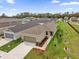 Aerial view showcasing the house, landscape, and driveway of the property at 8626 Caribbean Pine Way, Lakeland, FL 33809