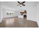 Open-concept living space flows into a kitchen with an island, pendant lighting and modern ceiling fan at 8626 Caribbean Pine Way, Lakeland, FL 33809