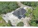 Aerial view of white home with dark roof situated in a wooded neighborhood at 30 Fisher Trail, Ocklawaha, FL 32179