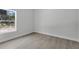 Cozy bedroom with view of the outdoors is painted light grey with light floors and trim at 30 Fisher Trail, Ocklawaha, FL 32179