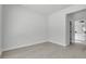 Inviting bedroom with light grey walls and floors is adjacent to a bathroom at 30 Fisher Trail, Ocklawaha, FL 32179