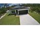 New home with driveway, two-car garage, and landscaping at 30 Fisher Trail, Ocklawaha, FL 32179