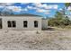 Back of the house with new windows and white exterior at 30 Fisher Trail, Ocklawaha, FL 32179