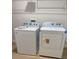 Well-lit laundry room features modern Whirlpool washer and dryer for convenient chores at 30 Fisher Trail, Ocklawaha, FL 32179