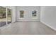 Bright living room features a sliding glass door and large windows offering plenty of natural light at 30 Fisher Trail, Ocklawaha, FL 32179