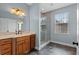 Charming bathroom with hexagonal tile flooring, glass shower, and wooden vanity at 41 E Spruce St, Orlando, FL 32804