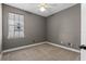 Comfortable bedroom featuring neutral carpet, ceiling fan, and natural light at 41 E Spruce St, Orlando, FL 32804