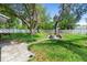 Spacious backyard featuring a stone fire pit, green grass, and a white fence at 3703 Pembrook Dr, Orlando, FL 32810