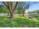 Large backyard featuring a fire pit, mature trees and a tall white fence at 3703 Pembrook Dr, Orlando, FL 32810