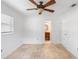 Bright bedroom featuring neutral tile floors, natural light, ceiling fan, and a glimpse into the adjoining bathroom at 3703 Pembrook Dr, Orlando, FL 32810