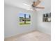 Bright bedroom featuring tiled floors, a modern ceiling fan, and a large window offering outside views at 3703 Pembrook Dr, Orlando, FL 32810
