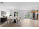 Dining Room with table, chairs, and rug is adjacent to the kitchen with stainless steel fridge at 3703 Pembrook Dr, Orlando, FL 32810
