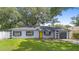 Inviting one-story home featuring a well-manicured lawn and a distinctive yellow front door at 3703 Pembrook Dr, Orlando, FL 32810