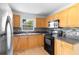 Traditional kitchen featuring stainless steel appliances and wood cabinets with dark countertops and tiled backsplash at 3703 Pembrook Dr, Orlando, FL 32810