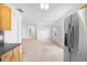 Spacious, tiled living room bathed in natural light, offering seamless transition from kitchen with stainless appliances at 3703 Pembrook Dr, Orlando, FL 32810