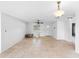 Bright, open living room with tiled floors, a ceiling fan, and ample natural light from a central window at 3703 Pembrook Dr, Orlando, FL 32810