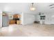 Bright living room flows into kitchen area featuring tile flooring, ceiling fan, and natural light at 3703 Pembrook Dr, Orlando, FL 32810