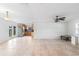 Bright living room flows into kitchen area featuring tile flooring, ceiling fan, and natural light at 3703 Pembrook Dr, Orlando, FL 32810
