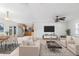 Living room with sofas, table, and rug is open to the kitchen with stainless steel fridge at 3703 Pembrook Dr, Orlando, FL 32810
