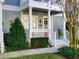 Charming front porch with red door, white railings, and lush greenery at 535 Crimson Ln, Winter Springs, FL 32708