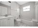 Bathroom with white subway tile shower, sink, and toilet at 5418 S Bracken Ct, Winter Park, FL 32792