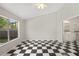 Bedroom with checkered tile floors and a view to the lawn at 5418 S Bracken Ct, Winter Park, FL 32792