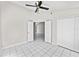 Bedroom features white tile floor, ceiling fan, and closet at 5418 S Bracken Ct, Winter Park, FL 32792