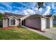 Charming single-Gathering home with a well-manicured lawn and a two-car garage at 5418 S Bracken Ct, Winter Park, FL 32792