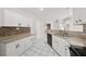 Clean kitchen with white cabinetry, granite countertops, and stainless steel sink at 5418 S Bracken Ct, Winter Park, FL 32792