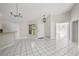 Open-concept living room with white tile flooring and modern lighting fixture at 5418 S Bracken Ct, Winter Park, FL 32792