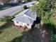 Tan house with gray roof and surrounding landscape at 620 Oak St, Auburndale, FL 33823