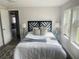 Well lit bedroom with a geometric headboard and rug at 620 Oak St, Auburndale, FL 33823