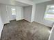 Simple bedroom with gray carpeting and a closet at 620 Oak St, Auburndale, FL 33823