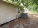 Rear exterior view of home with AC unit and tree at 620 Oak St, Auburndale, FL 33823