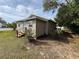 Side view of tan single story home with wooden steps at 620 Oak St, Auburndale, FL 33823