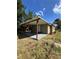 Tan house with carport and well-maintained lawn at 620 Oak St, Auburndale, FL 33823