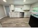 Modern kitchen with white shaker cabinets, quartz countertops, and stainless steel appliances at 620 Oak St, Auburndale, FL 33823