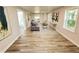 Open concept living space with gray couch and wood-look floors at 620 Oak St, Auburndale, FL 33823