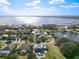 Aerial view showcasing the property, pool, and proximity to a large lake with beautiful community at 10542 Wittenberg Way, Orlando, FL 32832