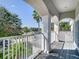 Charming balcony with white railings offering serene neighborhood views with lush trees at 10542 Wittenberg Way, Orlando, FL 32832