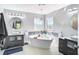Bright bathroom with soaker tub, dual sinks and patterned accent tile at 10542 Wittenberg Way, Orlando, FL 32832