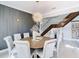 Open dining area featuring modern lighting, a stylish table setting, staircase, and contemporary decor at 10542 Wittenberg Way, Orlando, FL 32832