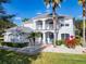 Charming two-story home featuring a second-story balcony and beautifully landscaped front yard with palm trees at 10542 Wittenberg Way, Orlando, FL 32832