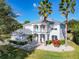 Stunning two-story home with lush landscaping, palm trees, and a welcoming front entrance and second story balcony at 10542 Wittenberg Way, Orlando, FL 32832