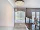Open foyer with crystal chandelier and large arched window at 10542 Wittenberg Way, Orlando, FL 32832