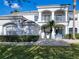 Inviting front entrance with a blue door, manicured shrubs, and a welcoming walkway leading to the home at 10542 Wittenberg Way, Orlando, FL 32832
