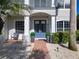 Inviting front entrance of a home with double blue doors, a brick walkway, and manicured landscaping at 10542 Wittenberg Way, Orlando, FL 32832