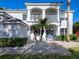 Close up of charming front entrance with blue door, decorative plants, and a brick walkway at 10542 Wittenberg Way, Orlando, FL 32832