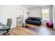 Cozy living room features wood floors, a comfortable couch, and workout equipment at 10542 Wittenberg Way, Orlando, FL 32832